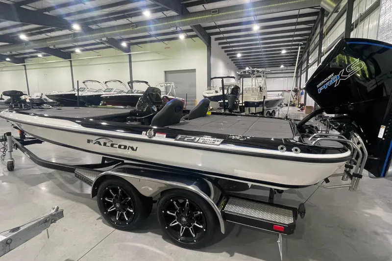 Slide: The Image of 2021 Falcon F21 boat in showroom, featuring sleek design and powerful Mercury Pro XS engine. - 13