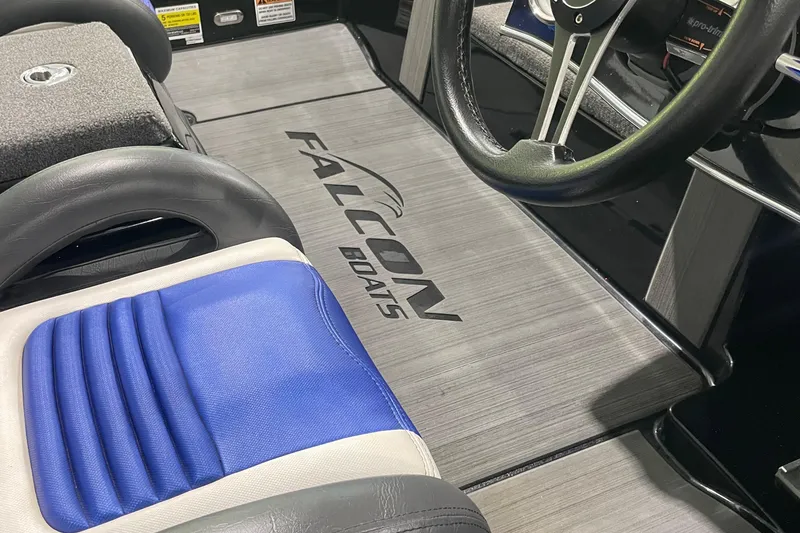 Slide: The Image of Interior of 2021 Falcon F21 boat with steering wheel and blue seat. - 4