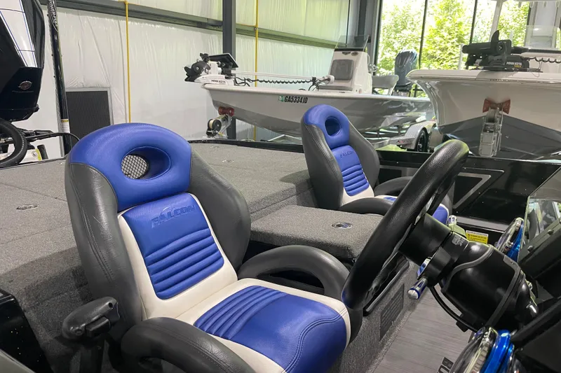 Slide: The Image of Interior of a 2021 Falcon F21 boat with blue and gray seating. - 6