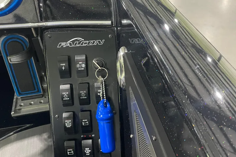 Slide: The Image of Control panel of a 2021 Falcon F21 boat with keychain and switches. - 7