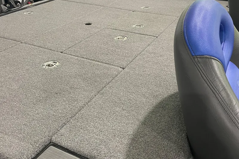 Slide: The Image of Carpeted deck of a 2021 Falcon F21 boat with blue seating. - 8