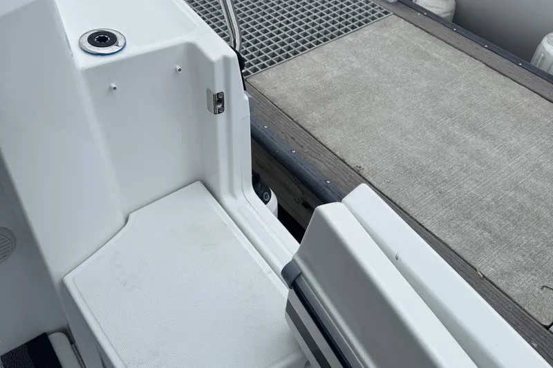 Slide: The Image of 2024 Jeanneau NC 795 boat deck with dockside view, featuring clean white surfaces. - 11