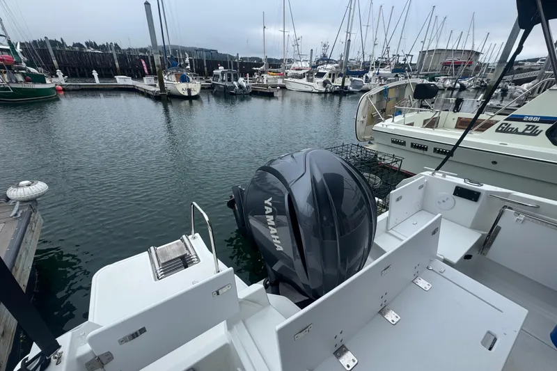 Slide: The Image of 2024 Jeanneau NC 795 with Yamaha engine docked at a marina. - 5