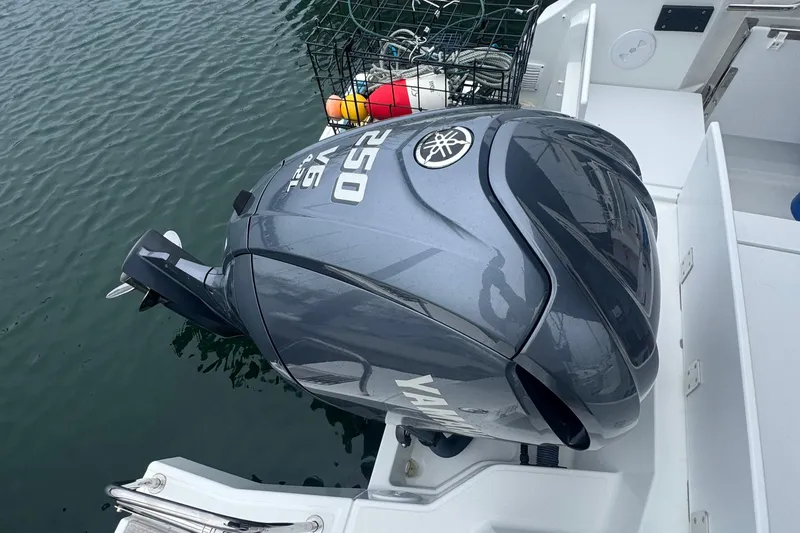 Slide: The Image of Yamaha V6 250 outboard motor on 2024 Jeanneau NC 795 boat, docked with fishing gear. - 6