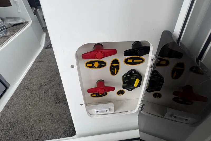 Slide: The Image of Control panel inside 2024 Jeanneau NC 795 boat, featuring switches and labels. - 9