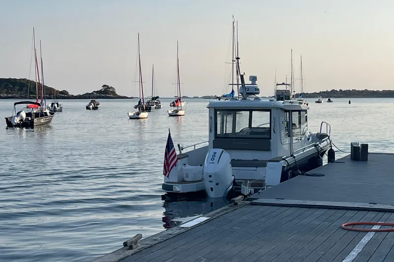 Slide: The Image of Boat docked at marina with sailboats in background, Nimbus c9-30, 2023 model. - 10