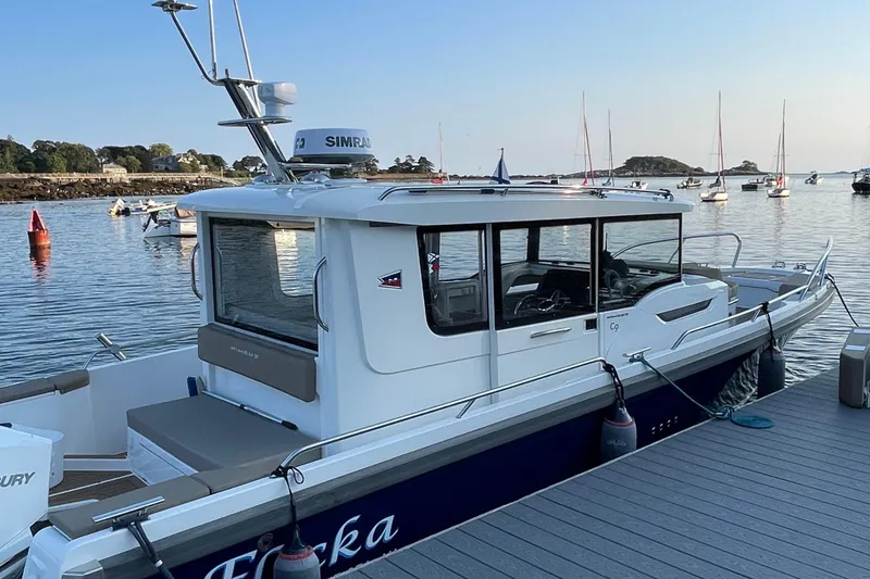 Slide: The Image of Nimbus C9-30 boat docked at a marina, surrounded by calm waters and sailboats. - 14