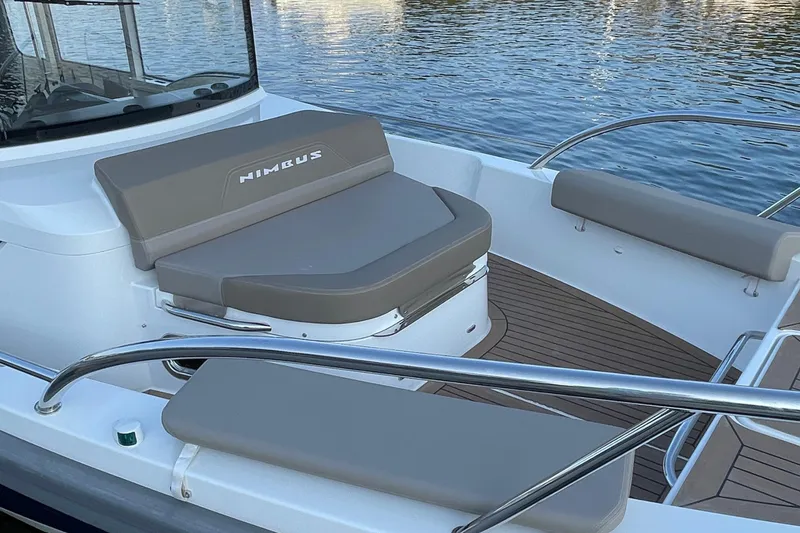 Slide: The Image of 2023 Nimbus c9-30 boat interior with cushioned seating and sleek design. - 20