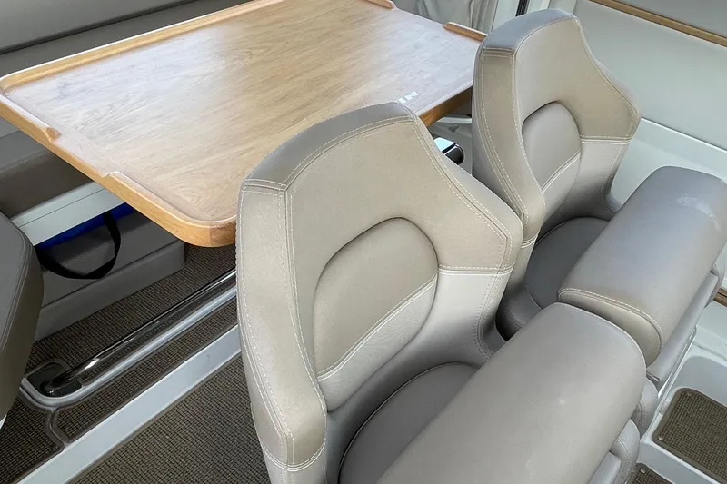 Slide: The Image of Interior of 2023 Nimbus c9-30 with beige seats and wooden table. - 26