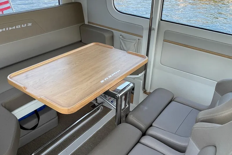 Slide: The Image of Interior of 2023 Nimbus C9-30 boat with wooden table and comfortable seating. - 27