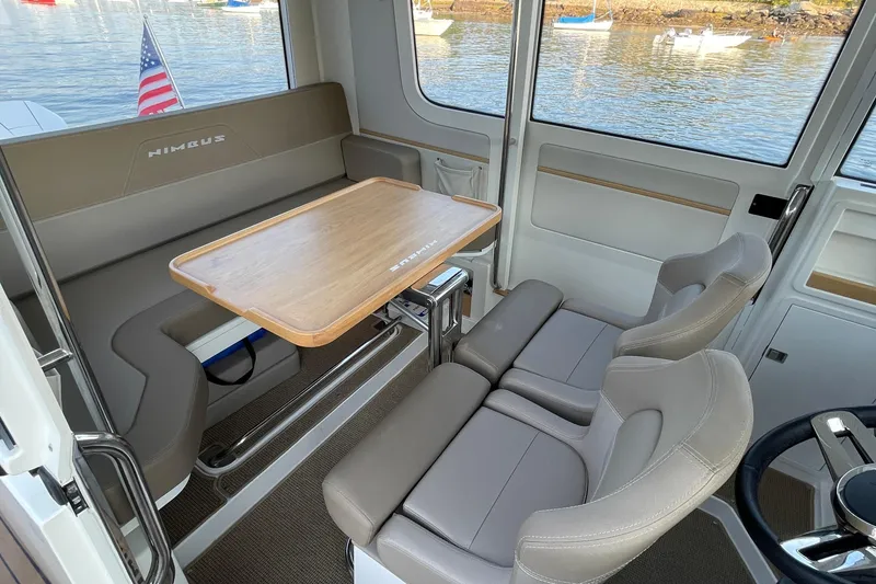 Slide: The Image of Interior of 2023 Nimbus C9-30 boat with seating and wooden table. - 28