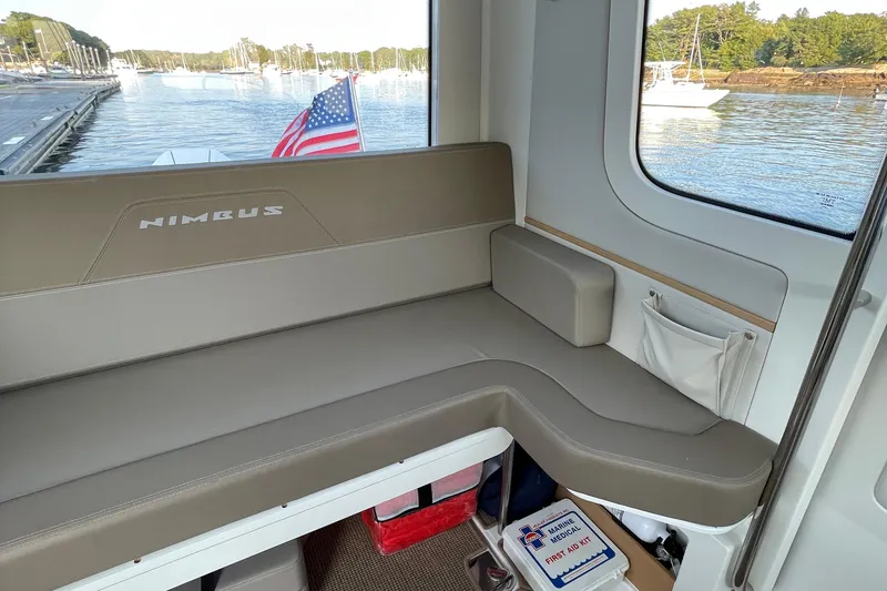 Slide: The Image of Interior of 2023 Nimbus C9-30 boat with seating and American flag view. - 30