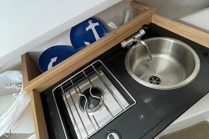 Slide: The Image of Compact kitchen area in a 2023 Nimbus c9-30, featuring a sink and stove. - 36