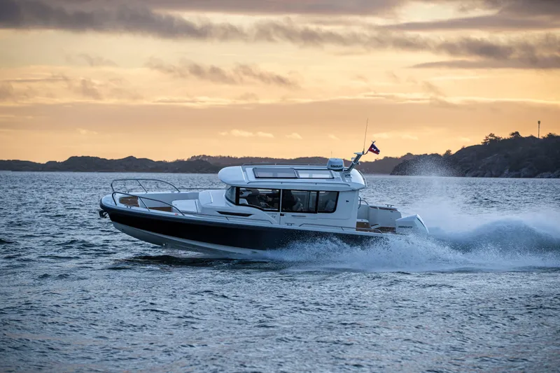 Slide: The Image of Nimbus C9-30 boat cruising at sunset, 2023 model, on open water. - 4