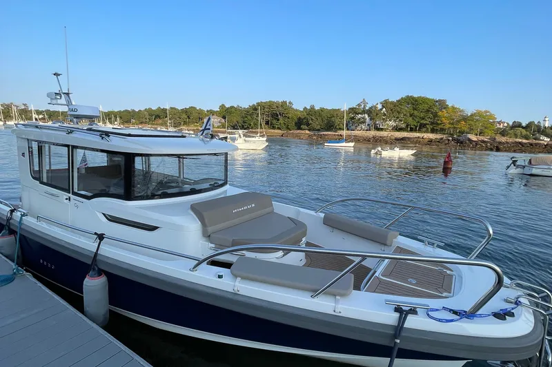 Slide: The Image of Nimbus C9-30 boat docked by a serene waterfront, 2023 model. - 42