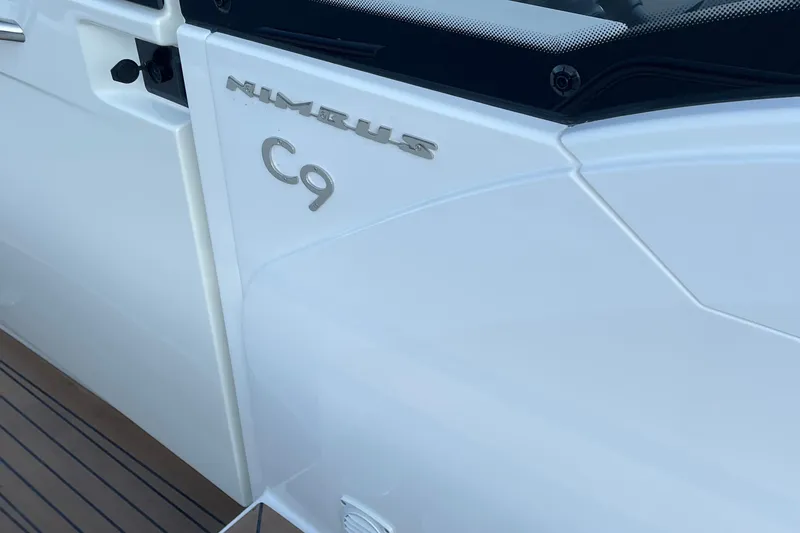 Slide: The Image of 2023 Nimbus C9 boat exterior with sleek white design and branding. - 44