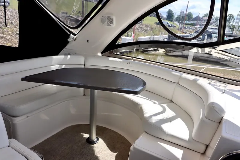 Slide: The Image of Luxurious interior of 2006 Regal Commodore 4460 yacht with white seating and table. - 10