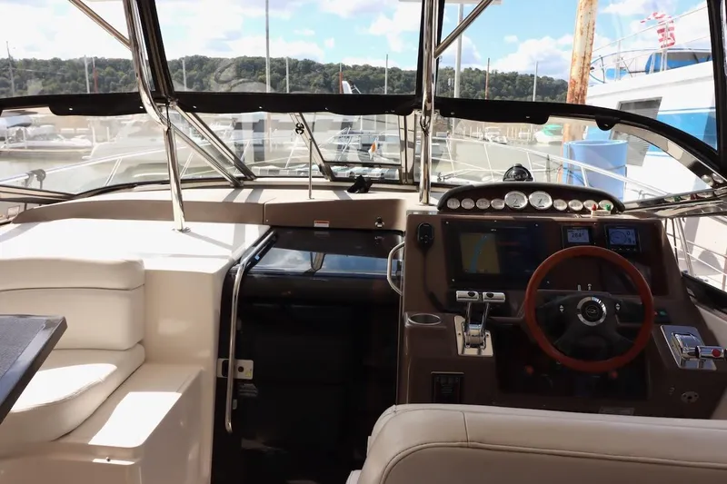 Slide: The Image of Interior view of 2006 Regal Commodore 4460 yacht cockpit with steering wheel and controls. - 13