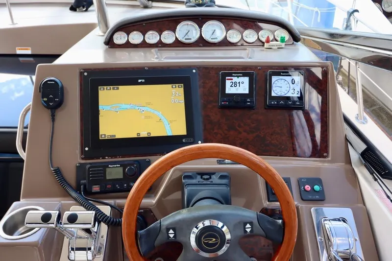 Slide: The Image of 2006 Regal Commodore 4460 yacht dashboard with navigation and control instruments. - 15