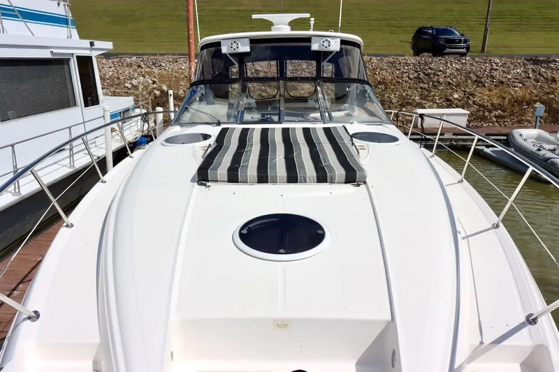 Slide: The Image of 2006 Regal Commodore 4460 yacht docked, featuring sleek design and spacious deck. - 17