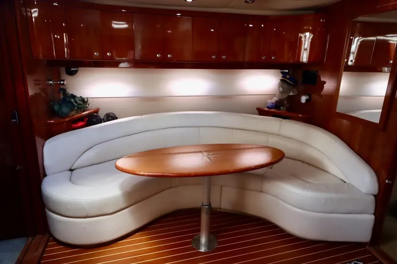 Slide: The Image of Luxurious 2006 Regal Commodore 4460 yacht interior with curved seating and wooden table. - 26