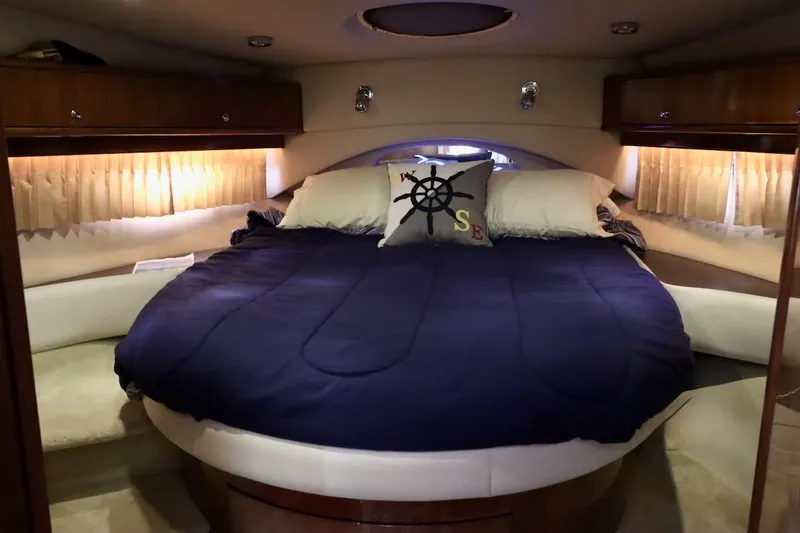 Slide: The Image of Luxurious 2006 Regal Commodore 4460 yacht bedroom with cozy bedding and nautical decor. - 27