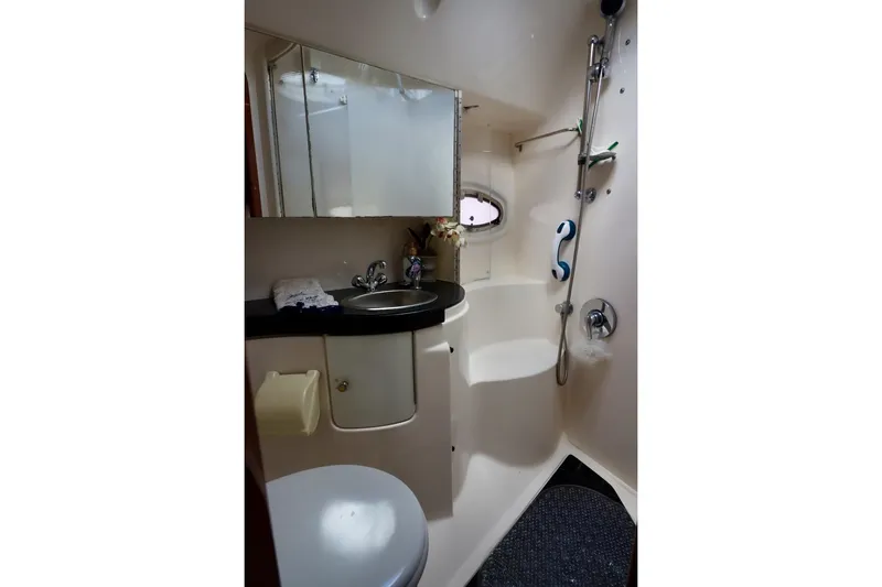 Slide: The Image of 2006 Regal Commodore 4460 yacht bathroom with sink, mirror, and shower. - 28
