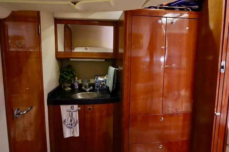 Slide: The Image of Luxurious 2006 Regal Commodore 4460 yacht interior with wooden cabinetry and sink area. - 29