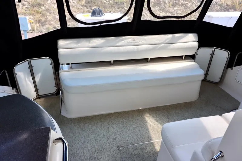 Slide: The Image of 2006 Regal Commodore 4460 interior with white seating and carpeted flooring. - 5