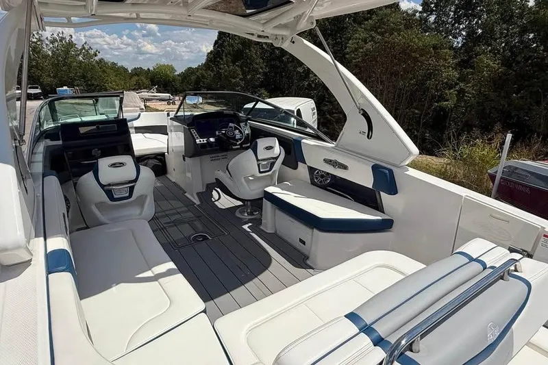 Slide: The Image of 2022 Chaparral 28 Surf boat interior with white and blue seating, sleek design. - 10