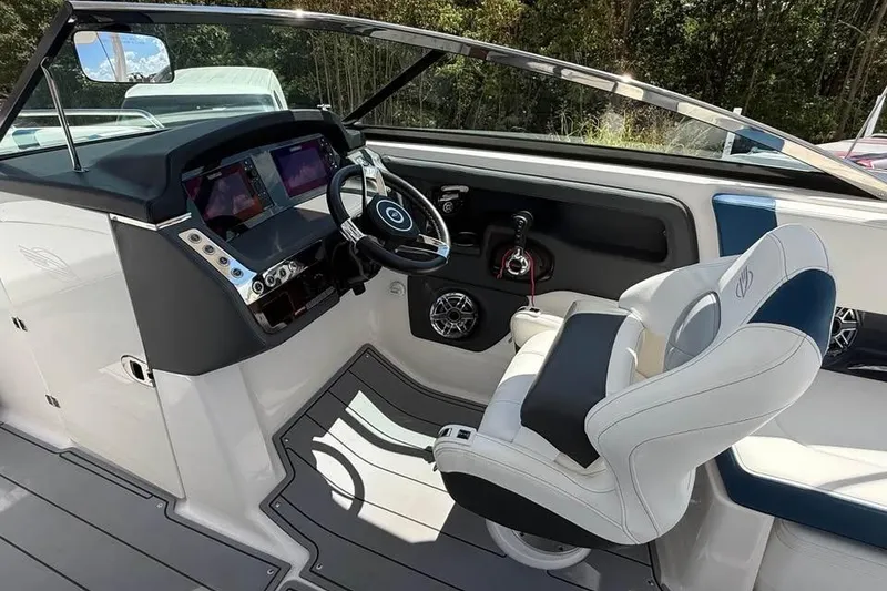 Slide: The Image of 2022 Chaparral 28 Surf boat interior with modern dashboard and comfortable seating. - 12