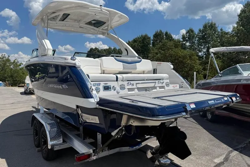 Slide: The Image of 2022 Chaparral 28 Surf boat on trailer, sunny day, blue and white design. - 5