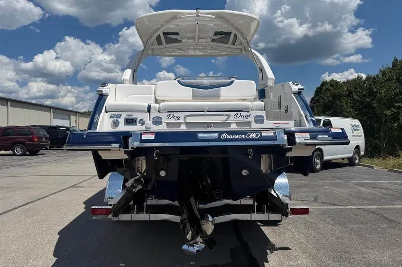 Slide: The Image of 2022 Chaparral 28 Surf boat rear view in parking lot under cloudy sky. - 6