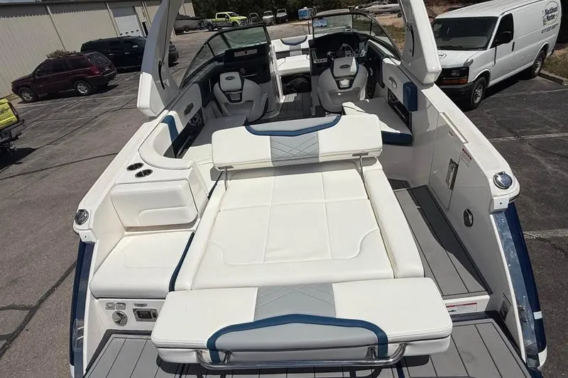 Slide: The Image of 2022 Chaparral 28 Surf boat interior with white seating and modern dashboard. - 9