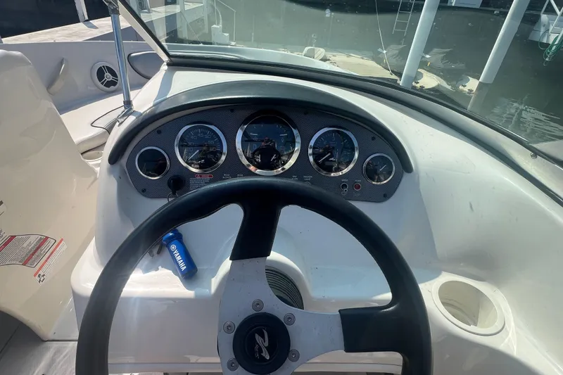 Slide: The Image of 2008 Sea Ray 205 Sport boat dashboard with steering wheel and gauges. - 2