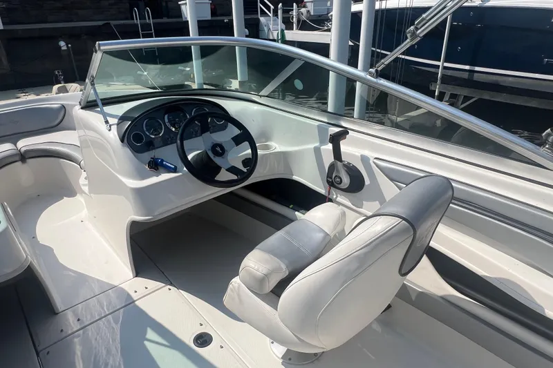 Slide: The Image of 2008 Sea Ray 205 Sport boat interior with steering wheel and seating. - 3