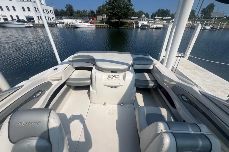 Slide: The Image of 2008 Sea Ray 205 Sport boat interior with seating, docked at a marina. - 5