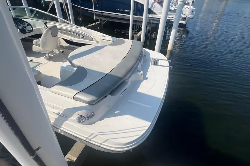 Slide: The Image of 2008 Sea Ray 205 Sport boat docked, featuring a sleek design and comfortable seating. - 9