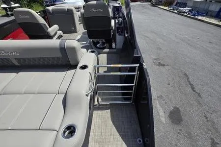 Slide: The Image of 2023 Barletta L25UCA pontoon boat interior with plush seating and open deck view. - 13