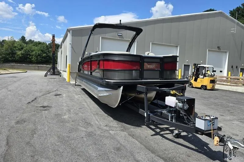 Slide: The Image of 2023 Barletta L25UCA pontoon boat on trailer outside industrial building. - 15