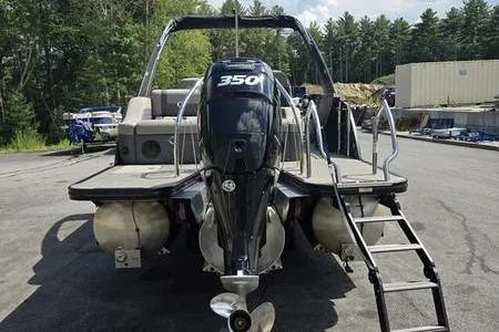 Slide: The Image of 2023 Barletta L25UCA pontoon boat with powerful 350 engine, docked outdoors. - 18