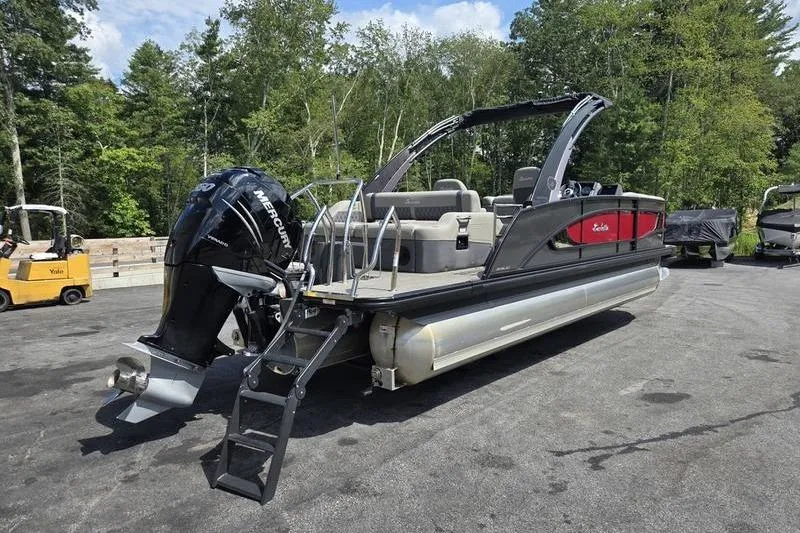 Slide: The Image of 2023 Barletta L25UCA pontoon boat with Mercury engine, parked outdoors. - 19