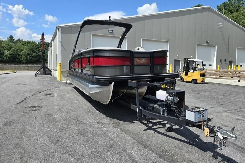 Slide: The Image of 2023 Barletta L25UCA pontoon boat on trailer outside industrial building. - 20