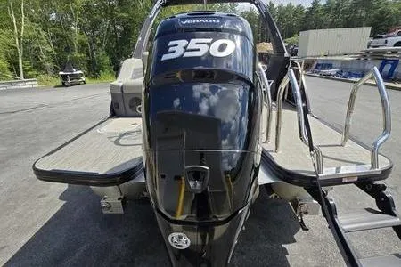 Slide: The Image of 2023 Barletta L25UCA boat with powerful 350 engine, docked outdoors. - 4