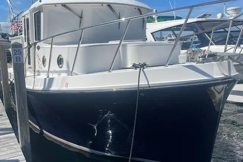 Slide: The Image of 2018 American Tug 365 docked, showcasing sleek design and sturdy build. - 19