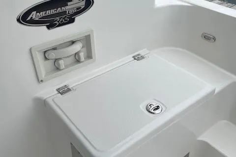Slide: The Image of 2018 American Tug 365 boat detail with storage compartment and logo. - 23