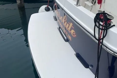 Slide: The Image of 2018 American Tug 365 docked, showing stern with ropes and fender. - 25