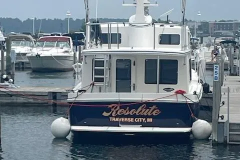 Slide: The Image of American Tug 365 boat docked, named "Resolute," Traverse City, MI, 2018 model. - 26