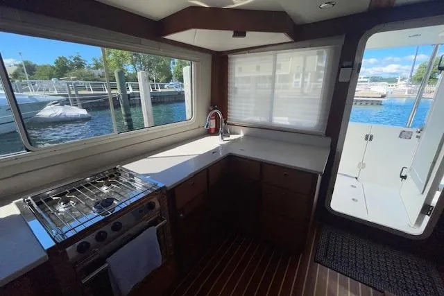 Slide: The Image of Interior of 2018 American Tug 365 with kitchen and marina view. - 27