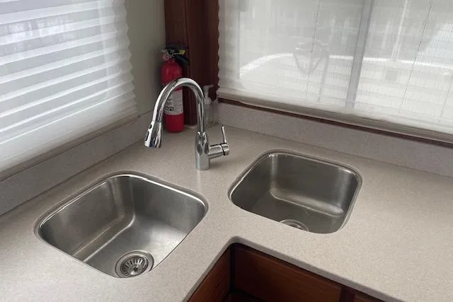 Slide: The Image of Modern kitchen sink area in 2018 American Tug 365 boat, featuring dual stainless steel sinks. - 28